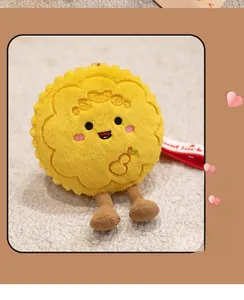 Close-up of rabbit mooncake plush charm with golden cloud embroidery and red good luck strap
