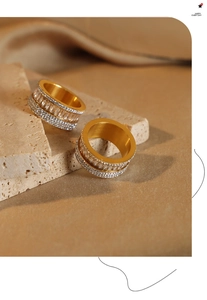 Detail of French style layered 18k gold plated titanium ring with pavé zircon stones