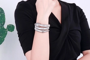 Detailed view of snake bracelet with realistic scale texture on model's wrist