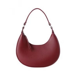 Minimalist deep red half-moon handbag in matte faux leather with sleek shoulder strap