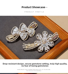 Close-up of sparkling zircon butterfly and flower hair clip with golden metal base