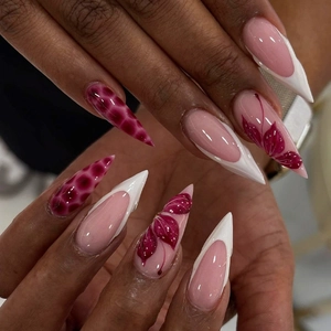 Long almond press-on nails with burgundy floral art and white French tips for women