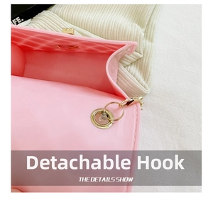 Detail view of pink silicone jelly bag with detachable metal hook and chain strap