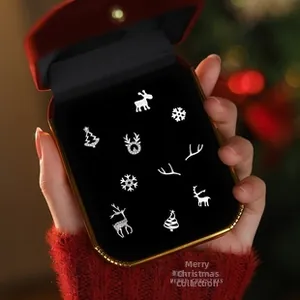 Macro shot of 5 pairs S925 silver Christmas earrings with reindeer and tree motifs