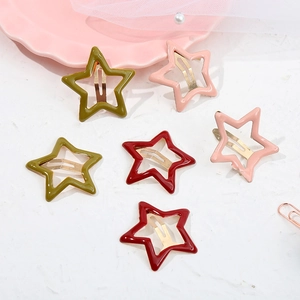 Flat lay of six colorful star-shaped metal hair clips with smooth plastic coating