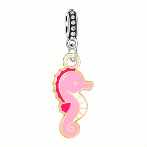 Detailed view of seahorse alloy pendant with pink enamel and golden metal borders