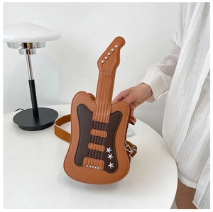 Detail of guitar-shaped crossbody bag with metallic rivets and brown color block finish