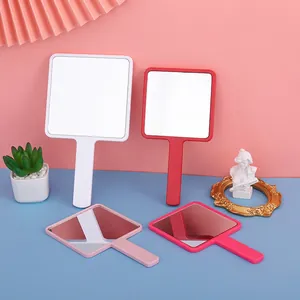 Square hand-held beauty mirror in white, red, and pink colors with ergonomic handle
