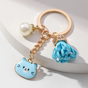 Cute blue cat keychain with floral tassel and pearl on a premium gold-toned ring