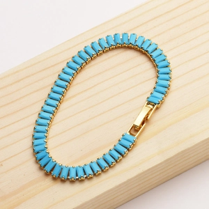 Detailed view of 18K gold plated bracelet featuring rectangular blue stones and secure clasp