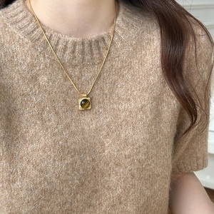 Tiger eye stone square pendant necklace with gold chain worn on camel knit sweater