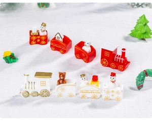 Close-up of miniature Christmas train sets with snowmen and bears in a festive snowy scene