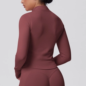Close-up of seamless ribbed texture and stitching on dark mauve slim fit yoga jacket