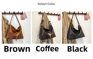 Three vintage leather tote bags in brown, coffee, and black displayed on a wall hanger