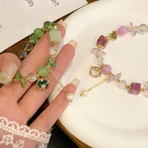 Detailed macro view of beaded planet bracelets with natural stones and adjustable chains