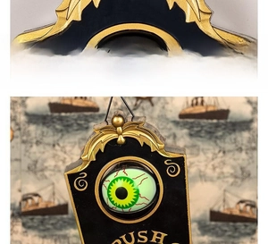 Close-up of Halloween eyeball doorbell with golden trim and push button for haunted house
