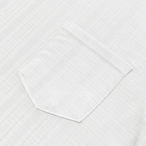 Close-up of white linen texture pocket detail on a breathable V-neck short sleeve shirt