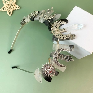 Crystal crown headband with sun, moon, and snake charms on raw natural stones