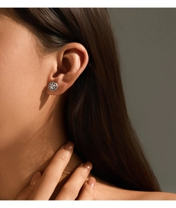 Close-up of hexagonal S925 silver stud earrings with center diamond and dark vintage border