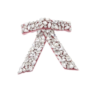 Elegant pink velvet bow hair clip featuring sparkling rhinestones and luxury pearls