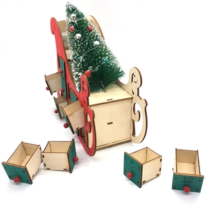 Wooden Christmas sleigh countdown calendar with green drawers and a mini pine tree