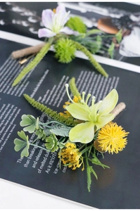 Detail of forest style boutonniere with greenery and twine wrapping for weddings