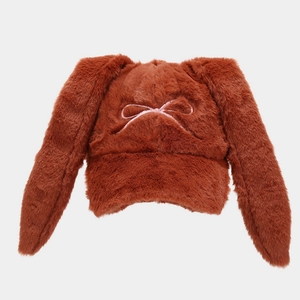 Detail of soft caramel plush baseball cap with long rabbit ears and pink bow embroidery