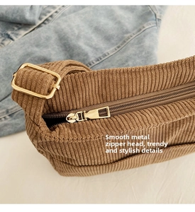 Close-up of brown corduroy tote bag showing textured fabric and smooth gold metal zipper