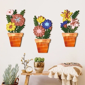 Three-piece floral wooden wall plaques set featuring colorful potted flower designs