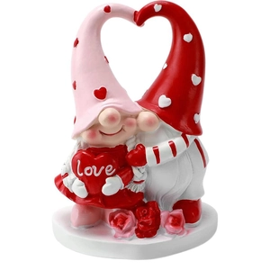 Valentine's Day couple gnome figurines with red hearts and 'Love' sign on white background