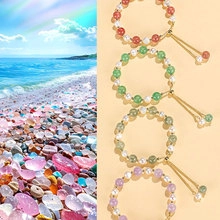 Detail of colorful beaded bracelets with natural pearls and adjustable gold chains