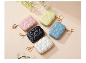 Detailed top view of quilted diamond pattern cosmetic bags in five various colors