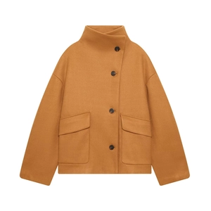 Detail of caramel wool jacket with asymmetric buttons and large flap pockets