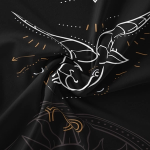 Macro shot of black zodiac tapestry fabric with detailed gold and white constellation print