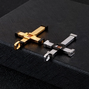 Polished gold and silver titanium steel cross pendants for men on textured background