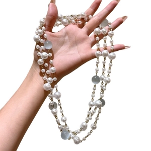 Baroque retro layered pearl and cat eye stone necklace with gold chain held in hand