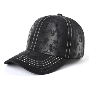 Detail of washed black denim baseball cap with rhinestone numbers and white stitching