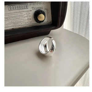 Detailed macro view of S925 sterling silver wide band ring with a polished finish