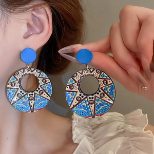 Artistic round sunflower oil painting earrings featuring blue and yellow enamel details