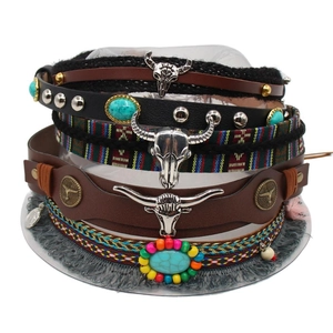 Detail of bohemian leather bracelets with turquoise stone and metal bull head charm