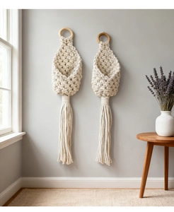 Detail of bohemian macrame woven baskets with natural wood rings and elegant tassels