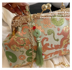 Detail of vintage embroidery handbag featuring floral patterns and gold floral frame