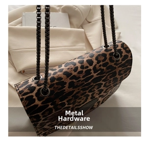 Detail show of leopard print crossbody bag with premium black woven chain and metal hardware