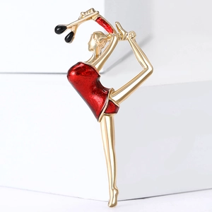 Artistic rhythmic gymnast brooch in gold and red enamel finish on white background