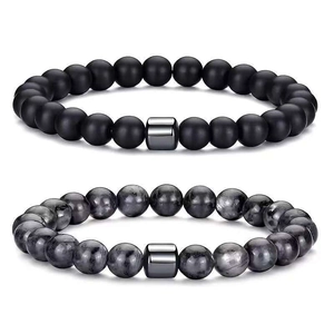 Men's natural stone bead bracelet set with matte black beads and silver metal charms