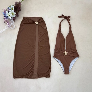 Detail of brown halter bikini and mesh skirt with decorative golden starfish buckles