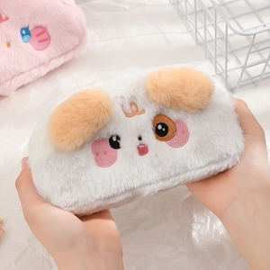 Cute white plush pencil case with cartoon dog face and orange ears held in hands