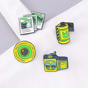 Vintage camera and film enamel pins set featuring a retro twin-lens design on white canvas