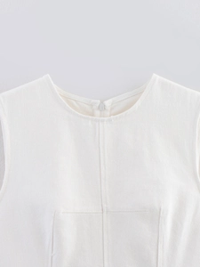 Detail of white sleeveless top with round neck and distinct twill cotton texture