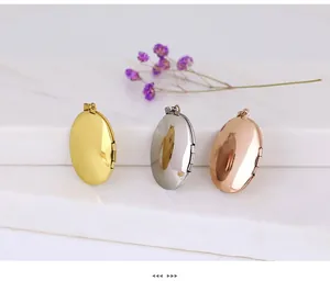 Three oval stainless steel photo lockets in gold, silver, and rose gold on marble steps